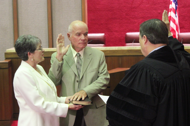 Charles Robinson is sworn in as state treasurer Wednesday afternoon beside his wife, Barbara Robinson.