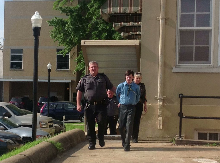 Zachary Holly is escorted from the courthouse after his court appearance.