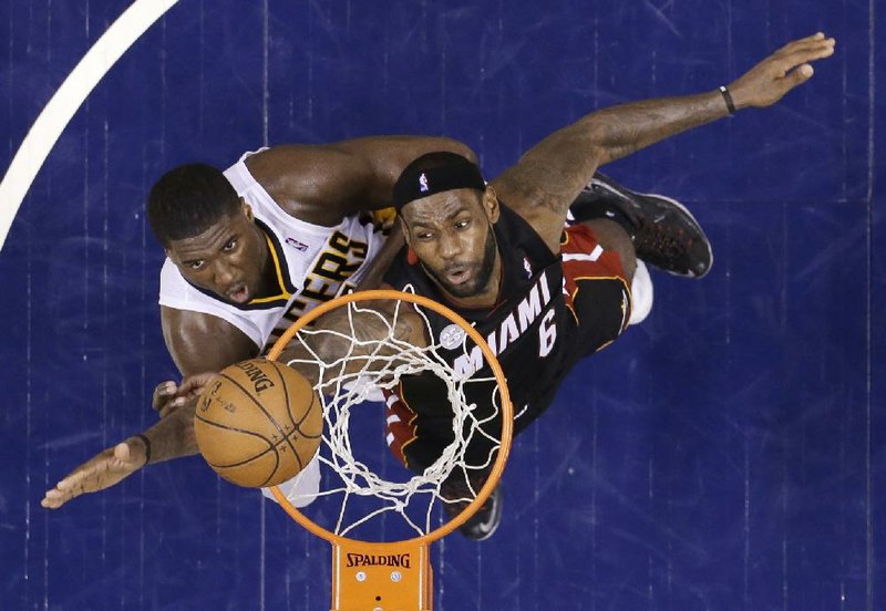 LeBron James of the Miami Heat (right) and Roy Hibbert of the Indiana Pacers position for a rebound during the Pacers’ 99-92 victory in Game 4 of the NBA Eastern Conference finals Tuesday night. Game 5 is tonight. 