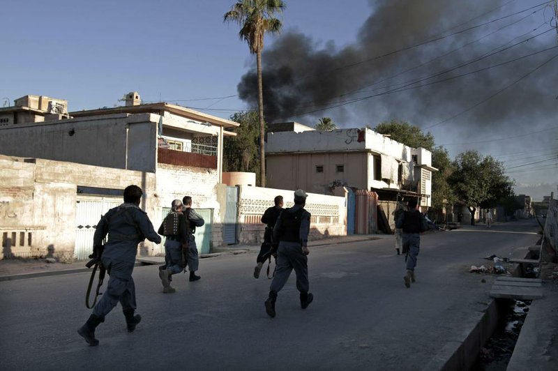Smoke rises from the International Red Cross building Wednesday in Jalalabad, Afghanistan, after an insurgent attack that left an Afghan guard dead. 