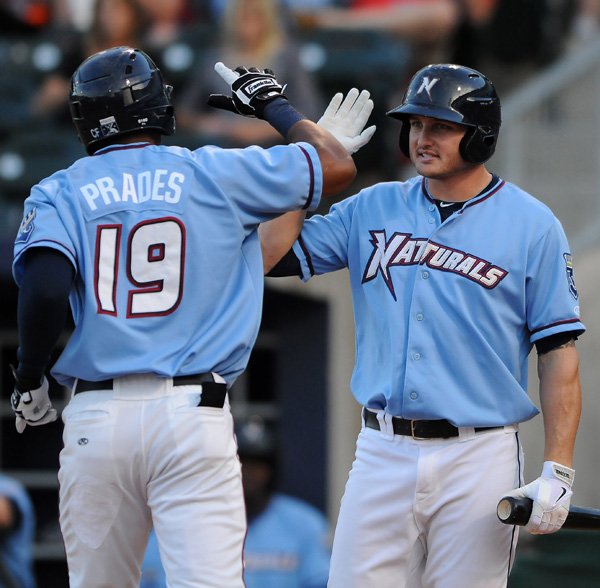 Yem Prades, left, high fives Carlo Testa, both with the Northwest Arkansas Naturals after his solo home run against the Corpus Christi Hooks on Wednesday at Arvest Ballpark in Springdale. Testa followed Prades’ home run with another home run in the bottom of the second inning. 