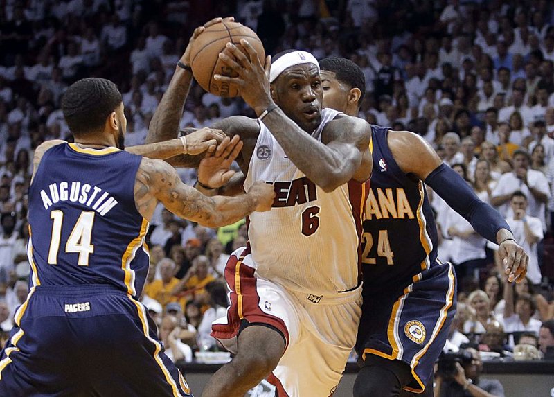 Miami’s LeBron James drives between Indiana’s D.J. Augustin (14) and Paul George (24) in the second half of the Heat’s 90-79 victory in Game 5 of the NBA Eastern Conference finals. 