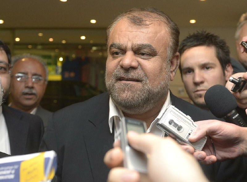 Iranian Minister of Petroleum Rostam Ghasemi talks to reporters Thursday as he arrived at a hotel ahead of today’s OPEC meeting in Vienna. 