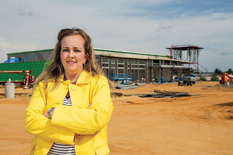 Nikki Chumley stands at the construction site of the Benton Convention Center scheduled to open in the fall. She will become the director of the facility Monday, marketing the center and the city.