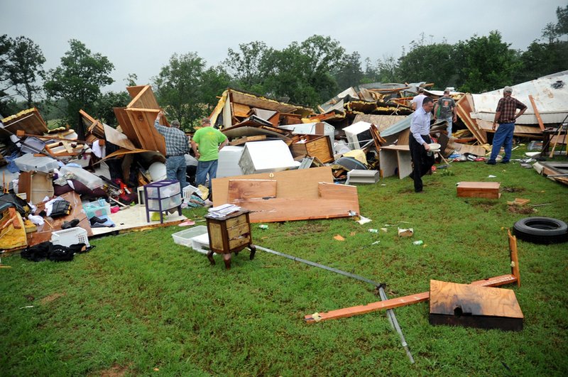 Family and friends sift through the remains of a home on Nubbin Ridge Road just west of Ballard Road, located off Old Dallas Road in Pearcy, after severe storms, and possibly a tornado, ripped through the area Thursday, May 30, 2013. 