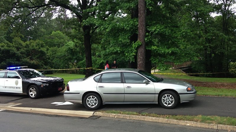 Crime-scene tape blocks an area on the University of Arkansas at Little Rock campus Friday after a body was discovered in Coleman Creek near the university's fine arts building.