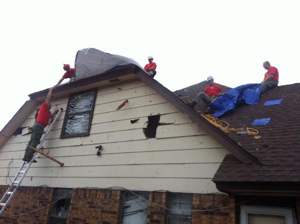 Members of Sheep Dog Impact Assistance help out with tornado damage in Moore, Okla., in 2013. The nonprofit volunteer group’s second annual charity ball is Saturday. 