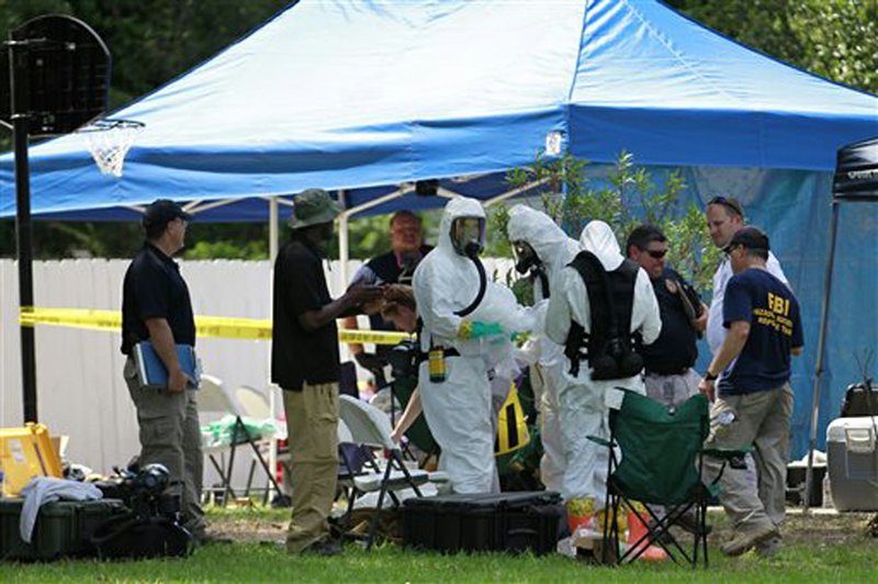 Members of an FBI hazardous materials team prepare to enter a residence in New Boston, Texas, Friday, May 31, 2013, in connection with a federal investigation surrounding ricin-laced letters mailed to President Barack Obama and New York Mayor Michael Bloomberg.