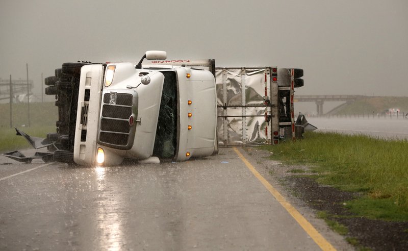 Overturned trucks block a frontage road off I-40 just east of 81 in El Reno, Okla., after a tornado moved through the area on Friday, May 31, 2013.