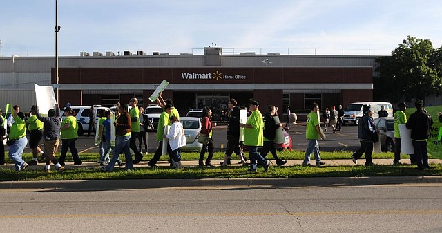 STAFF PHOTO SAMANTHA BAKER
Protestors from Organization United for Respect at Walmart march Monday, June 3, 2013, outside Walmart Stores, Inc.'s Home Office in Bentonville. Monday marked the start of Walmart's annual Shareholders Week. Protestors of the company routinely picket the company during Shareholders Week. The group, mostly consisting of current and former Walmart associates from around the country, was protesting "the illegal relation against workers who speak out for a better Walmart," according to a press release by the organization.