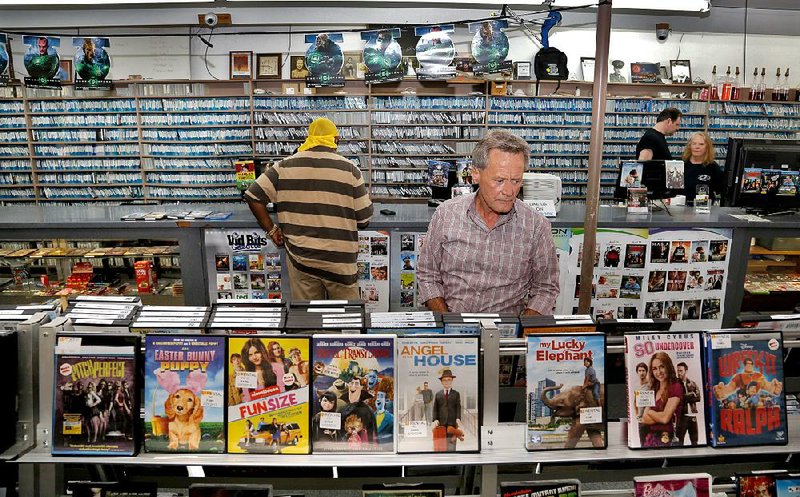  RAO VIDEO regular George Neal browses the new releases at the downtown Little Rock video rental store. 052413