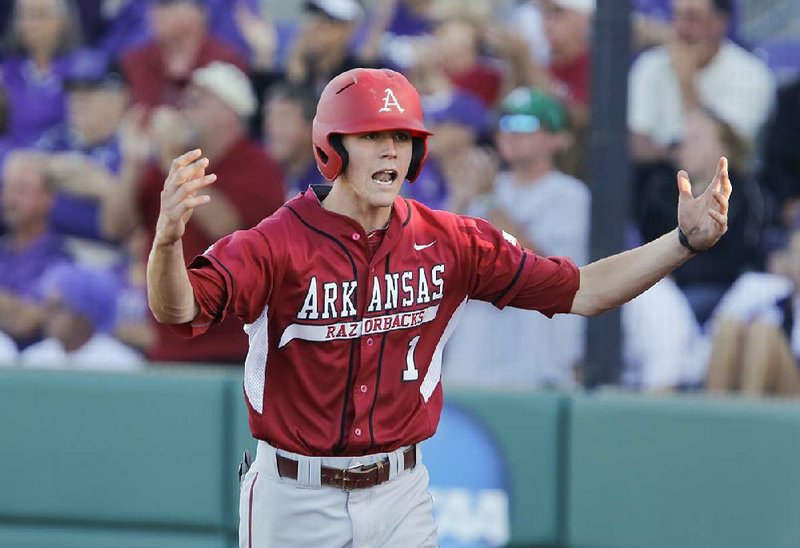 Arkansas' Brian Anderson celebrates after scoring a run against Kansas State in the first inning in an NCAA baseball regional game in Manhattan, Kan., Sunday, June 2, 2013. (AP Photo/Jeff Tuttle)