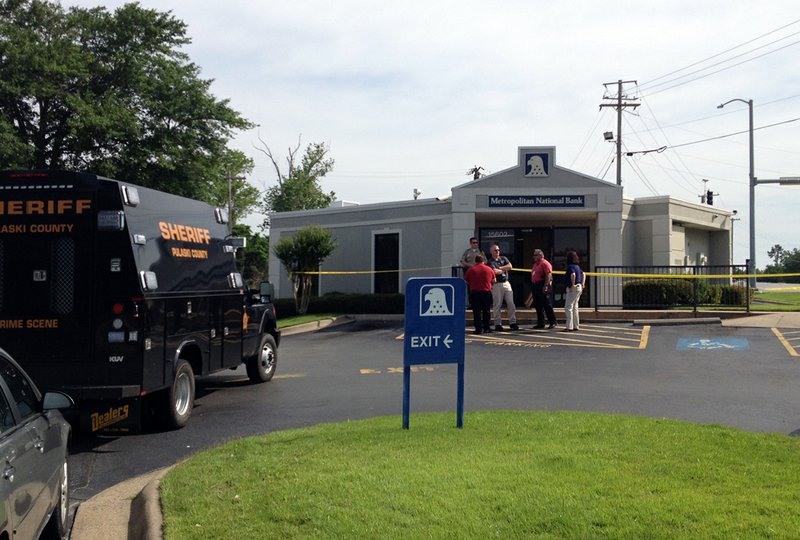 Authorities respond Tuesday, June 4, 2013, to a report of a robbery at the Metropolitan National Bank branch at 15602 Arch Street Pike in Pulaski County.