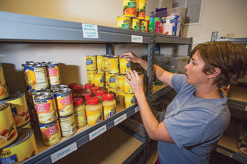 Sarah Robbins stocks canned food in the All Created Equal (ACE) food pantry in Hot Springs. ACE is located at Lakeside High School and provides canned goods, fruits and vegetables, as well as household necessities to members of the community. It is run by volunteers and students and takes donations daily.