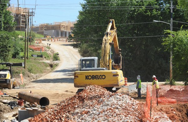 Work continues Monday at the site of The Vue, a luxury apartment complex south of Martin Luther King Jr. Boulevard in Fayetteville, a day after a worker was electrocuted. 