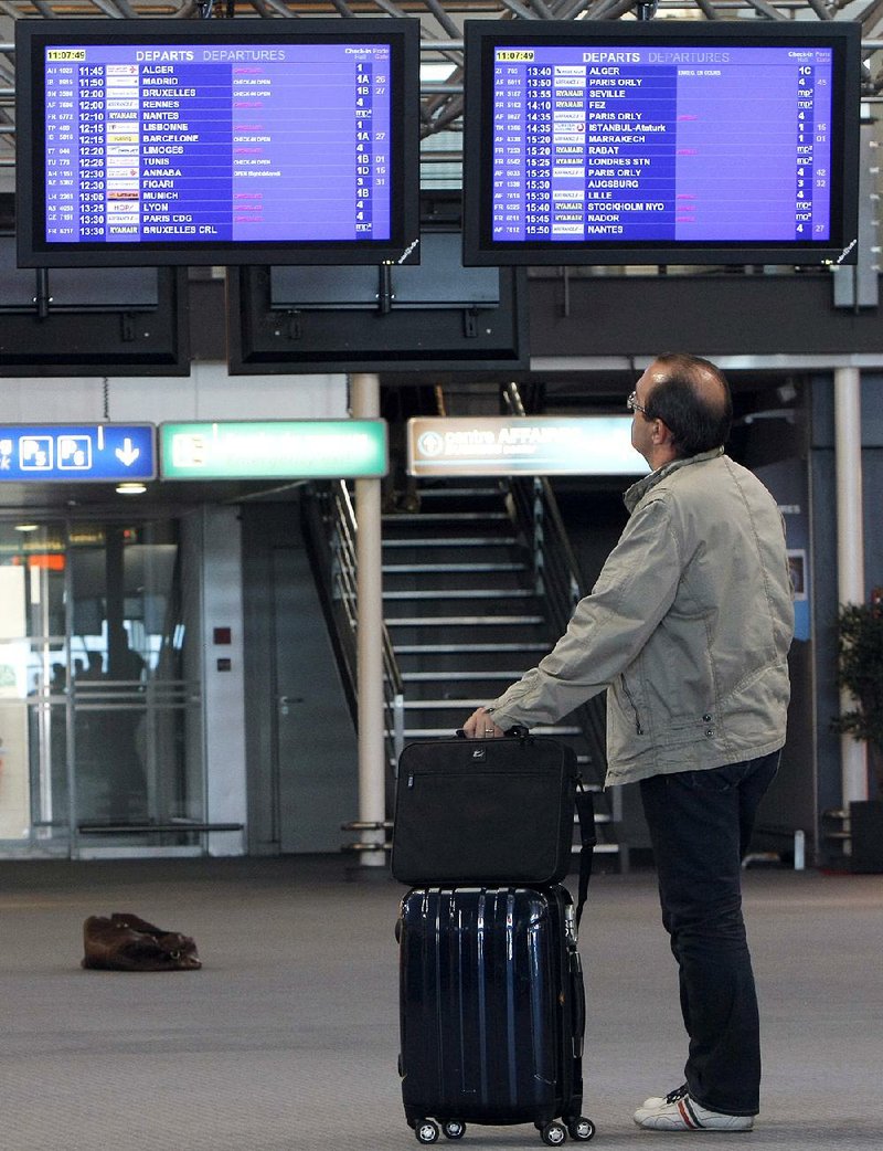 A passenger checks flight information at Marseille-Provence Airport, in Marignane, southern France, Tuesday, June 11, 2013. France's main airports have cut their flight timetables in half to cope with a three-day strike by air traffic controllers.  The Civil Aviation Authority said that some 1,800 flights were cut Tuesday in France to protest against a plan to centralize control of Europe's air space.  (AP Photo/ClaudeParis)