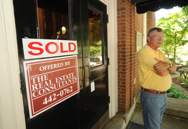 New building owner Jim Huson speaks to passersby Wednesday, June 12, 2013, at the old post office building on the Fayetteville square.