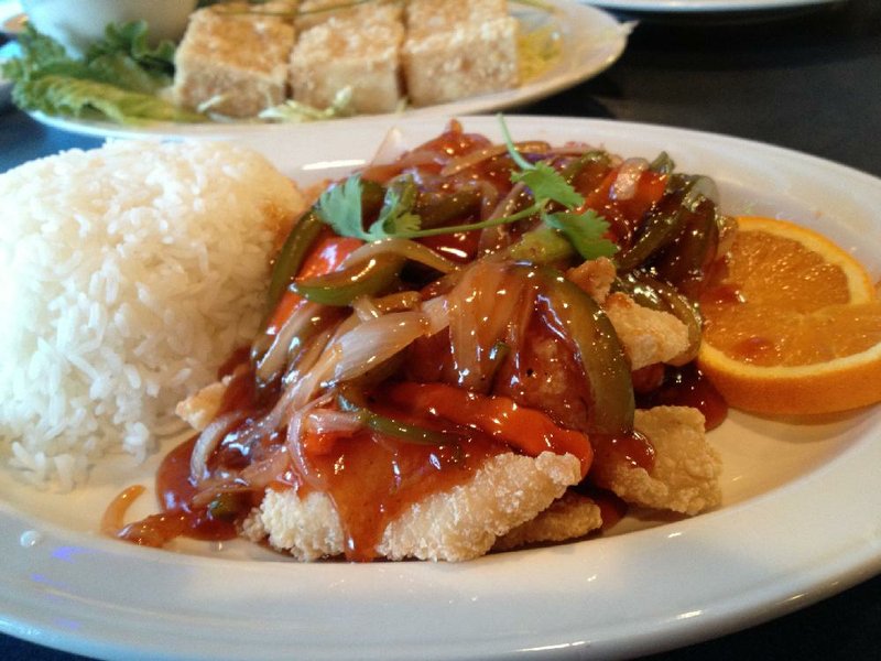 Ca Chua Ngot, “house special fi sh fillet with orange,” features fried fish smothered in onions and orange sauce at Mike’s Cafe Chinese and Vietnamese Cuisine, 5501 Asher Ave. 