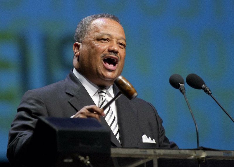 The Rev. Fred Luter, Southern Baptist Convention president, presides over action Wednesday in Houston, where members overwhelmingly approved a resolution denouncing the Boy Scouts of America for deciding to accept gay Scouts. 