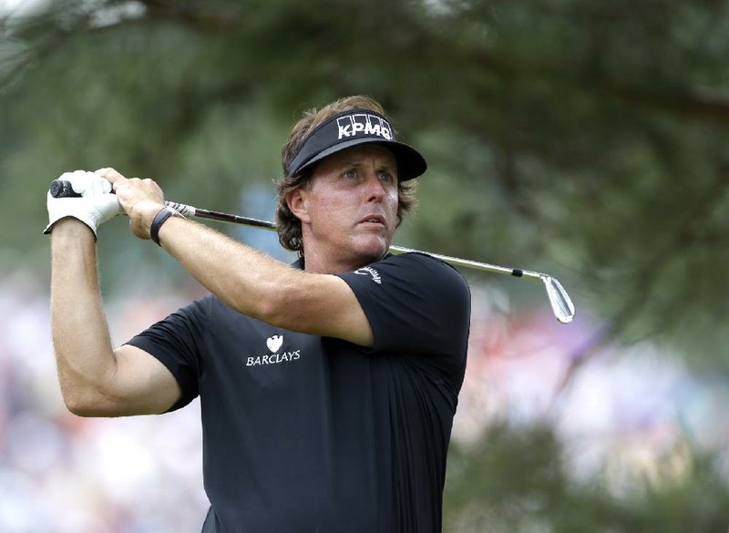 Phil Mickelson tees off with an iron on the 360-yard, par 4 eighth hole during the first round of the U.S. Open Thursday at Merion Golf Club in Ardmore, Pa. Mickelson did not pack a driver in his bag. 