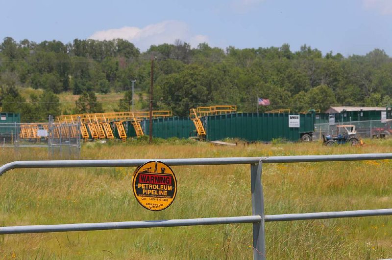 Rows of waste containers sit Thursday at a Pegasus pipeline site along Arkansas 36 northeast of Conway. Arkansas Attorney General Dustin McDaniel said Thursday that Exxon Mobil is storing the waste illegally. 