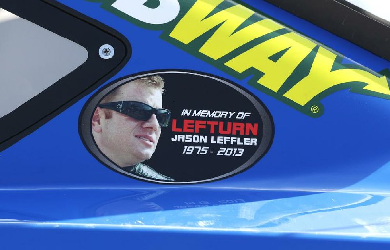 A Jason Leffler sticker is seen on Carl Edwards’ car after Friday’s qualifying for Sunday’s Quicken Loans 400 at Michigan International Speedway in Brooklyn, Mich. The death of NASCAR driver Leffler at a dirt-track race near Philadelphia earlier this week has brought more attention to small, local tracks, where some big names like Tony Stewart still show up to race on occasion. 