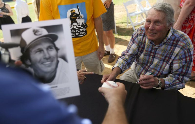 Hall of Famer Brooks Robinson, who was born and raised in Little Rock, talks with fans Saturday during an autograph session to help raise funds for a renovation of Little Rock’s Lamar Porter Field. 