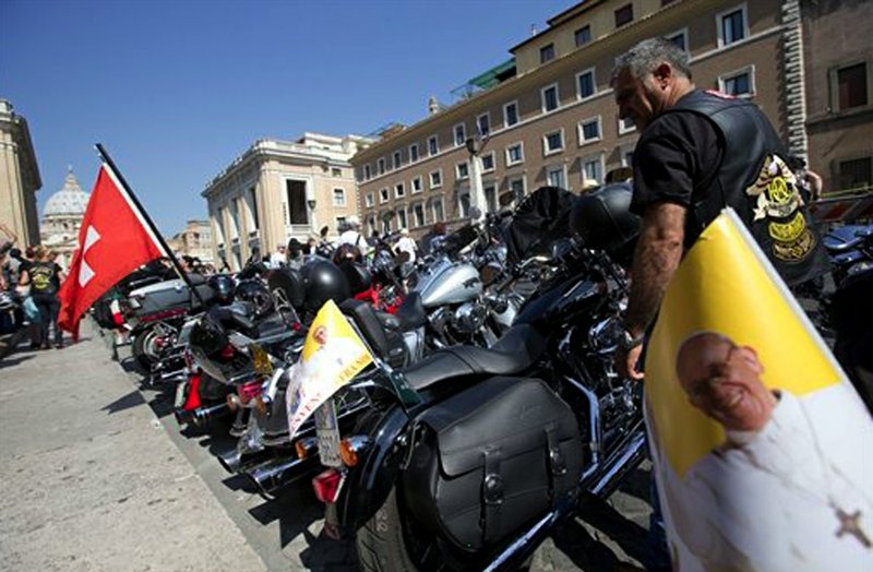 Harley Davidson motorcycles riders park their motorcycles in Via della Conciliazione leading to the Vatican, seen at left, as they wait for Pope Francis to drive by to bless them ahead of mass in St. Peter's Square, at the Vatican, Sunday, June 16, 2013. The riders are gathered in Rome for a four-day event to celebrate the motorcycle company's 110th anniversary.