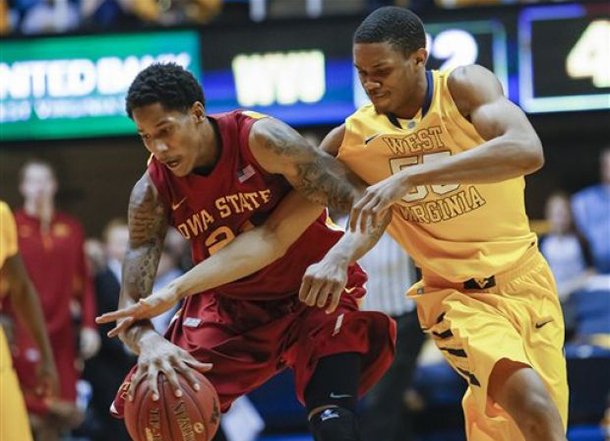 Keaton Miles, right, fouls Iowa State's Will Clyburn in the second half of an NCAA college basketball game at WVU Coliseum in Morgantown, W.Va., Saturday, March 9, 2013. Miles transferred to Arkansas and will officially begin class July 1. (AP Photo/David Smith)