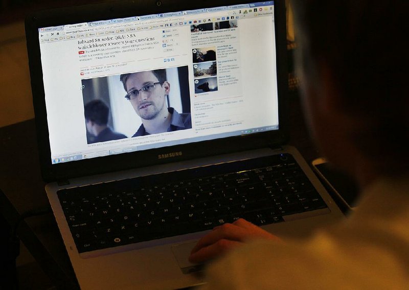 Tom Grundy, an activist, blogger and organizer of support for Edward Snowden, browses the live chat with Snowden on the website of The Gaurdian on Monday in his house in Hong Kong. 