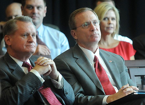 University of Arkansas chancellor David Gearhart (left) and athletics director Jeff Long listen during a Sept. 14, 2012 presentation in Fayetteville. 