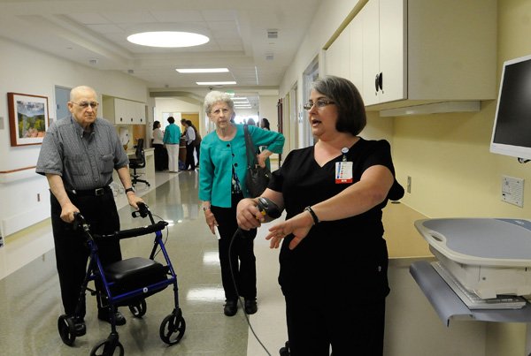 Dean Park, left, and Shirley Park take a tour Tuesday of the senior behavioral health unit at Mercy Medical Center in Rogers guided by Deann Thompson, right, a registered nurse. A dedication of the unit was held Tuesday morning. 