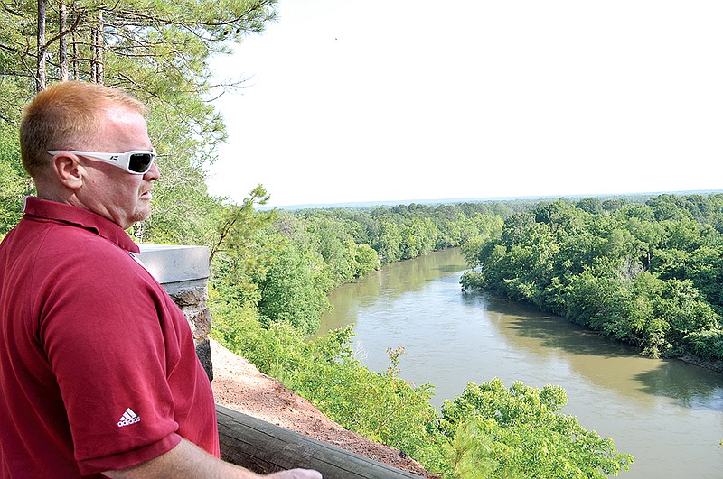Mike Volz, director of the Arkadelphia Parks and Recreation Department, tells some of the history of DeSoto Bluff, which overlooks the Ouachita River. Arkadelphia has built a paved road off North 10th Street (U.S. 67) to a small parking lot. From there, visitors can walk down a broad paved path to DeSoto Bluff.