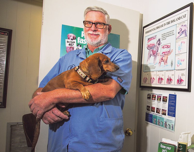 Dr. Michael Liles, a veterinarian with the Liles Animal Clinic in Searcy, encourages pet owners to make sure their dogs or other pets get plenty of water and protection during hot summer days.