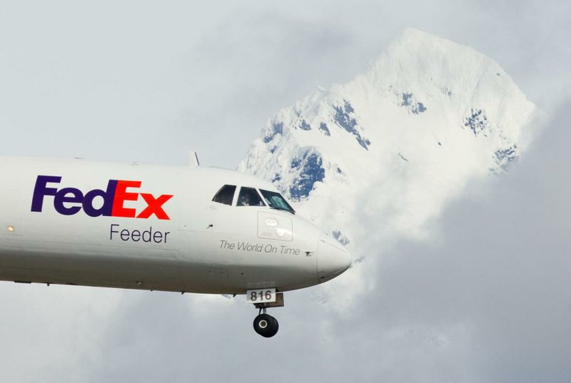 A FedEx cargo plane approaches Juneau International Airport in Alaska in April. The company on Wednesday reported a $303 million fourth-quarter profit. 