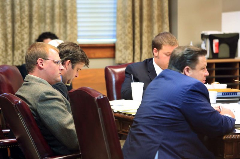 Former Little Rock police officer Josh Hastings (left) listens to testimony with his lead attorney Bill James (far right) after his manslaughter trial began Wednesday at the Pulaski County Courthouse. 