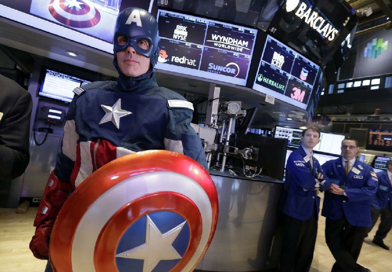 Specialists watch as a Captain America character poses for photos Wednesday before opening-bell ceremonies on the floor of the New York Stock Exchange. 