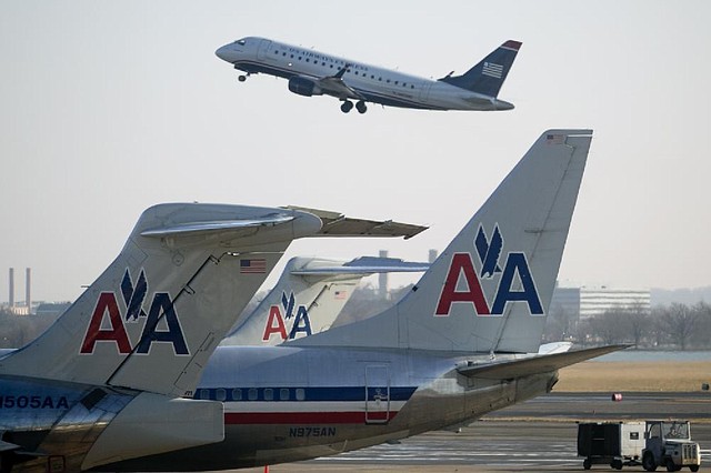 A US Airways Group Inc. jet takes off at Reagan National Airport in Washington, D.C., in February. Competition on more than 1,600 routes would be reduced if the American Airlines and US Airways merger is approved, a government review said. 