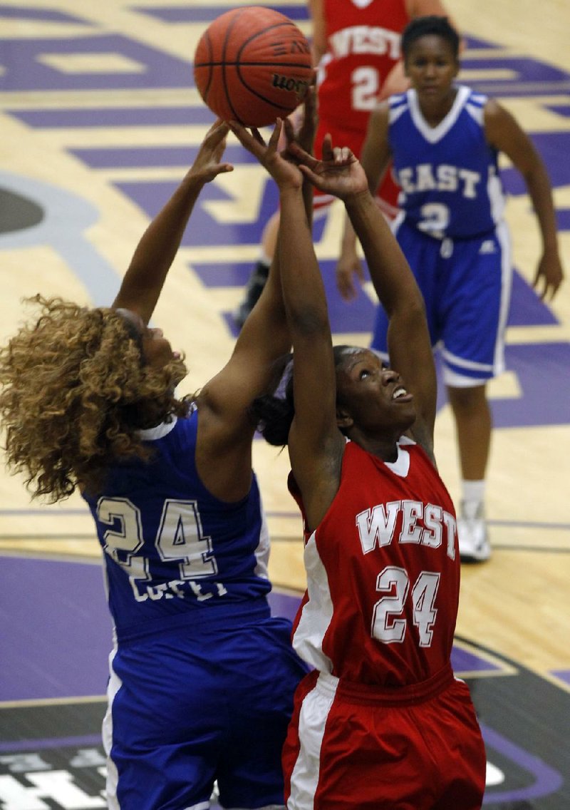 Little Rock Hall’s Tierra Coffey (left) of the East and Ashdown’s LaBreshia Scott of the West battle for a rebound during Thursday night’s girls All-Star basketball game in Conway. 