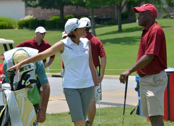 Mike Anderson, right, University of Arkansas head basketball coach, chats Thursday with pro golfer Juli Inkster before they tee off of the 11th tee during the pro-am at the Walmart NW Arkansas Championship at Pinnacle Country Club in Rogers. 