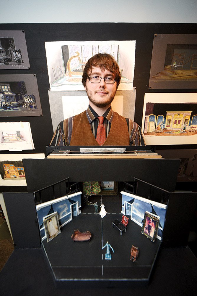Arkadelphia Arts Center executive director Nick Langley holds one of the stage mock-ups that is part of a theater-design exhibit at the center.