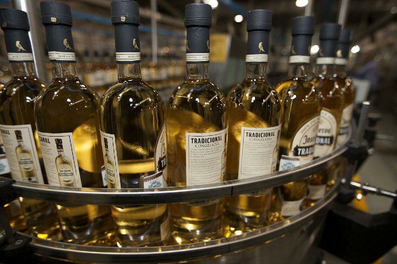 Bottles of Jose Cuervo Tradicional move along the production line at the Tequila Cuervo La Rojena S.A. de C.V. bottling factory in Guadalajara, Mexico, on Thursday, Nov. 22 2012. There are more than 200 types of agave in Mexico, but use of the blue agave plant was made compulsory in the last century to the issuance of the Official Mexican Standard for Tequila production. Photographer: Susana Gonzalez/Bloomberg