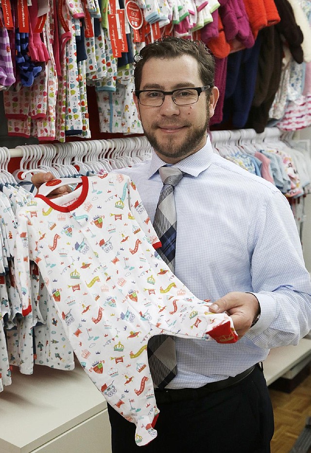 In this Friday, May 31, 2013 photo, Lawrence Scheer displays one of his company's items in their showroom, in New York. Scheer's company, Magnificent Baby, manufactures its products in China and then sells them in about 20 countries around the world. (AP Photo/Mark Lennihan)