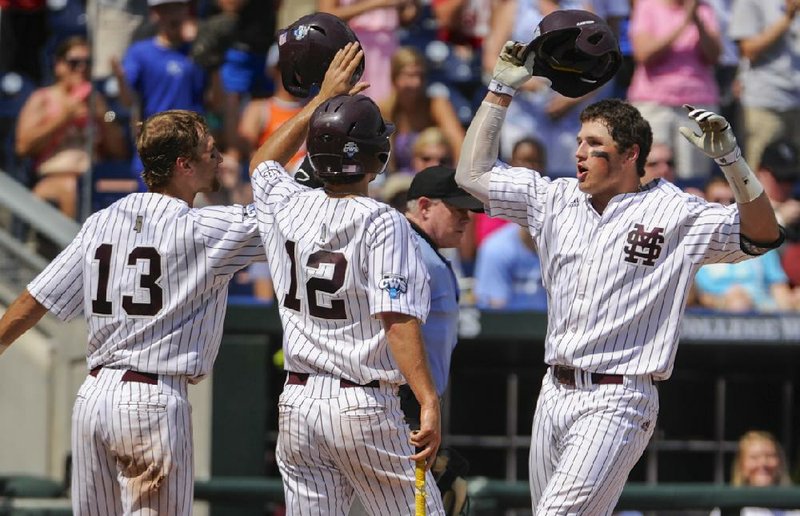 Mississippi State's Hunter Renfroe, right, celebrates with teammates Brett Pirtle, left, and Adam Frazier (12) after hitting a three-run home run against Oregon State in the fifth inning of an NCAA College World Series baseball game in Omaha, Neb., Friday, June 21, 2013. (AP Photo/Francis Gardler)