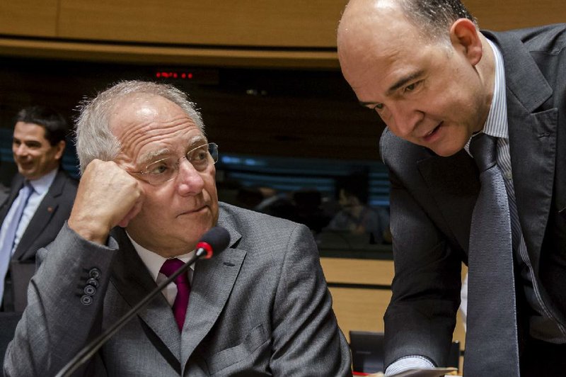 German Finance Minister Wolfgang Schauble, left, talks with his French counterpart Pierre Moscovici during a European finance ministers meeting in Luxembourg, Friday, June 21, 2013. (AP Photo/Geert Vanden Wijngaert)