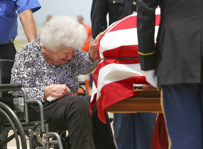 6/21/13
Arkansas Democrat-Gazette/STEPHEN B. THORNTON
Dorothy Martin weeps as she touches the casket holding the remains of her brother, Korean War Veteran Marvin E. Omans Friday moments after it was unloaded from a plane at Bill and Hillary Clinton National Airport. Cpl. Omans was reported missing in action on December 3, 1950.