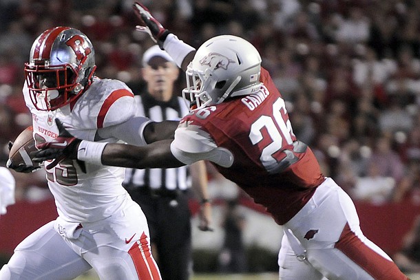 Arkansas safety Rohan Gaines tackles former Rutgers running back Jawan Jamison on Sept. 22, 2012, at Donald W. Reynolds Razorback Stadium. The two teams will complete the home-and-home series in New Jersey this season.