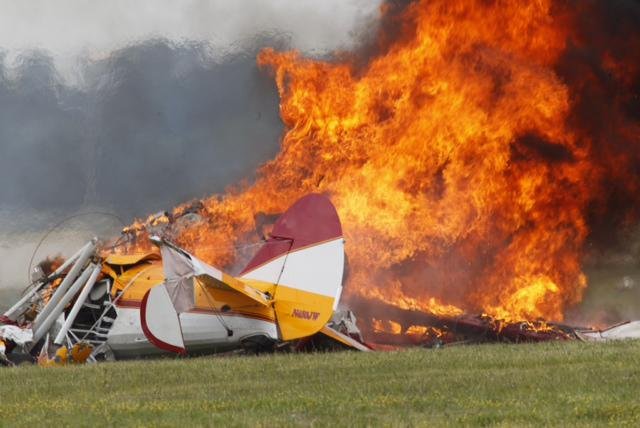 Flames pour out of a plane after it crashed Saturday, killing the pilot and a wing walker who were performing at an air show in Dayton, Ohio. A video shows the 450-horsepower Stearman first flying upside down — the woman daredevil perched on top of the wing — then tilting and crashing to the ground. No spectators were injured.