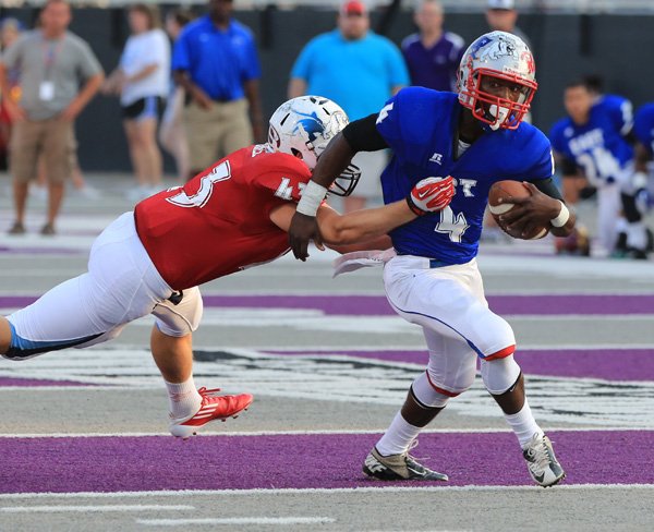 Peyton Squires, West All-Star who played for Springdale Har-Ber, tackles the East’s Caelon Harden of Little Rock Parkview on Friday during the All-Star game at the University of Central Arkansas in Conway. 