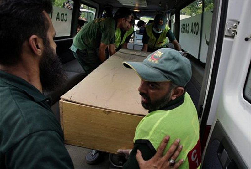 Pakistani rescue workers unload the casket of a foreign tourist, who was killed by Islamic militants, from an ambulance to shift in a morgue of local hospital in Islamabad, Pakistan, Sunday, June 23, 2013. Islamic militants wearing police uniforms shot to death nine foreign tourists and one Pakistani before dawn as they were visiting one of the world’s highest mountains in a remote area of northern Pakistan that has been largely peaceful, officials said.
